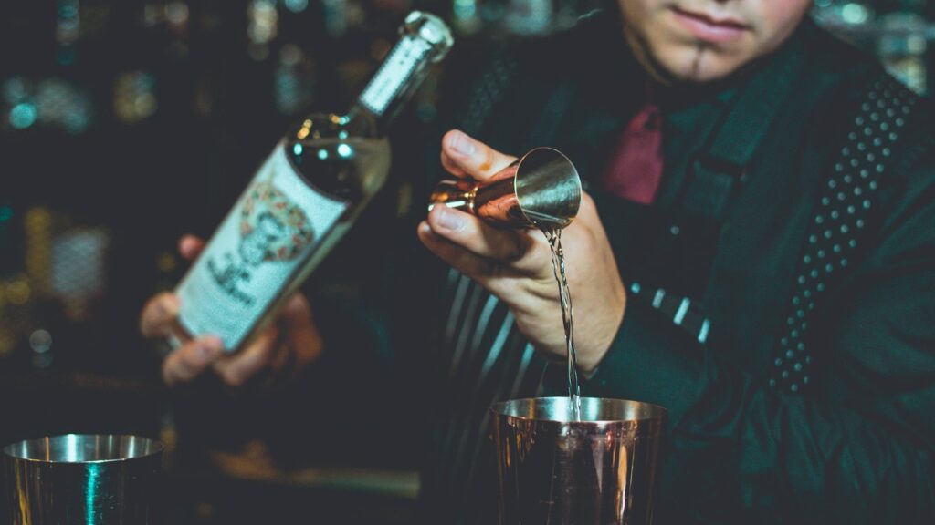 bartender mixing tequila on table